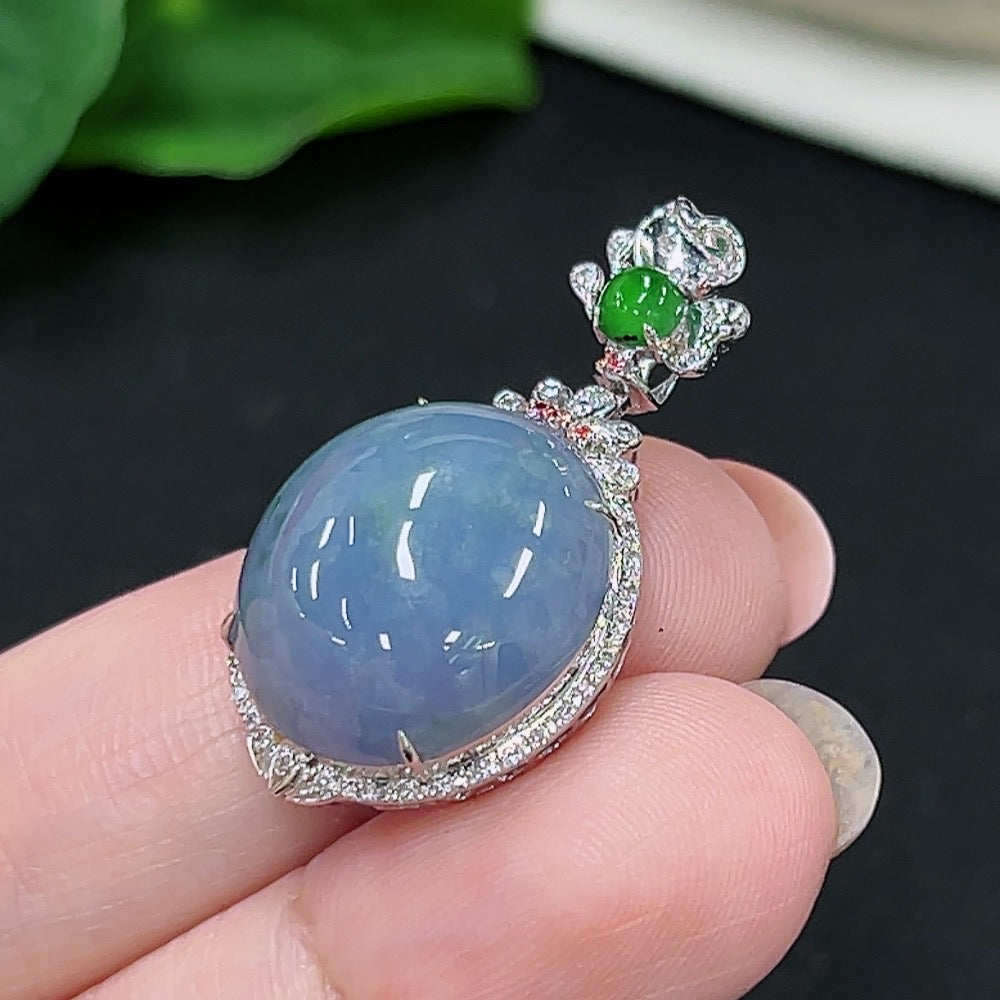 Jadeite cabochon pendant with 18k gold setting and four non-diamond accents, weighing approximately 5.45g.
