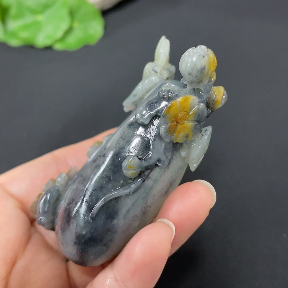 Huiliu certified Hetian jade ornament featuring butterflies and flowers, showcasing detailed carvings and smooth, polished surface.