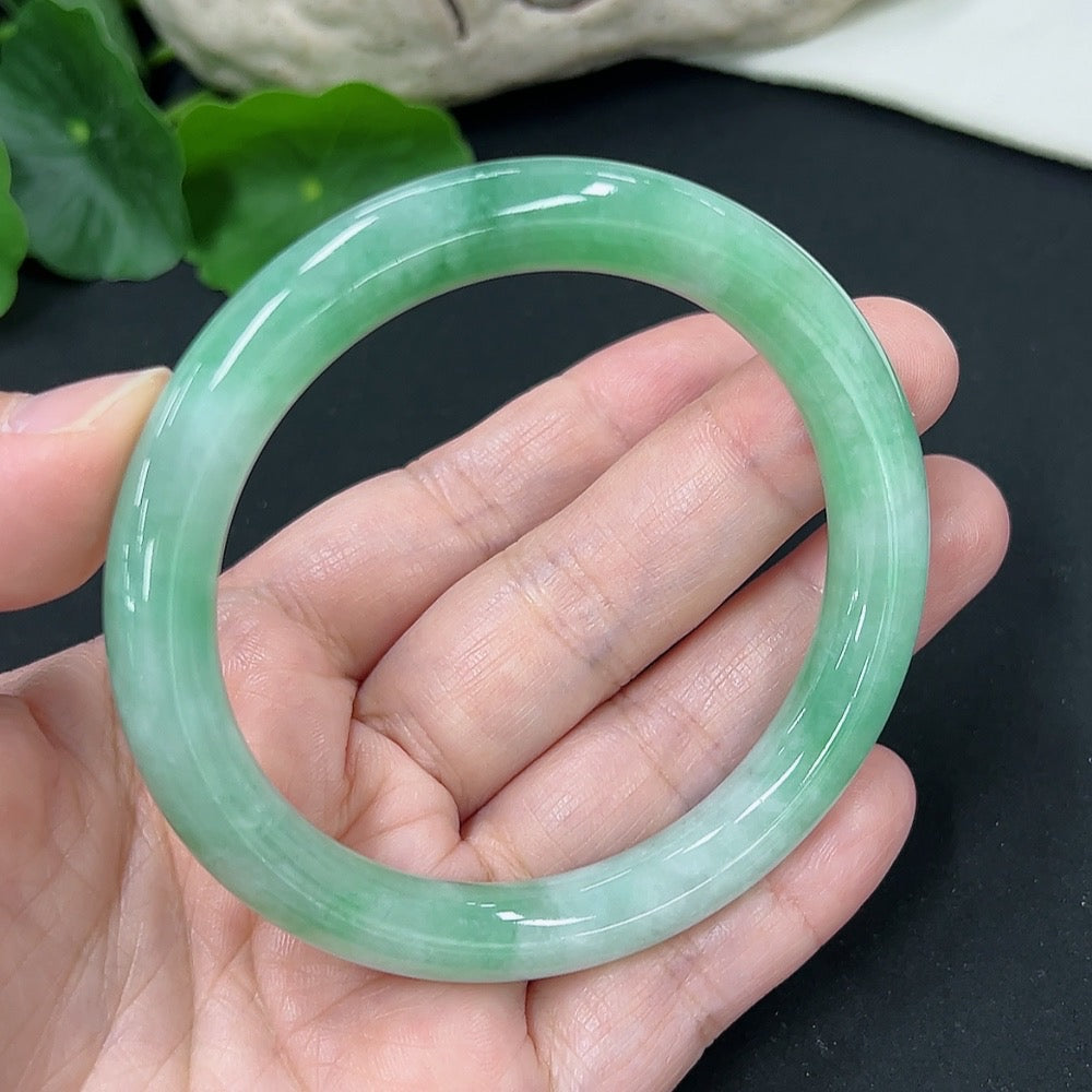 HKHQ jadeite round bangle, size 56, weighing approximately 43 grams, featuring smooth, polished green jadeite bracelet.