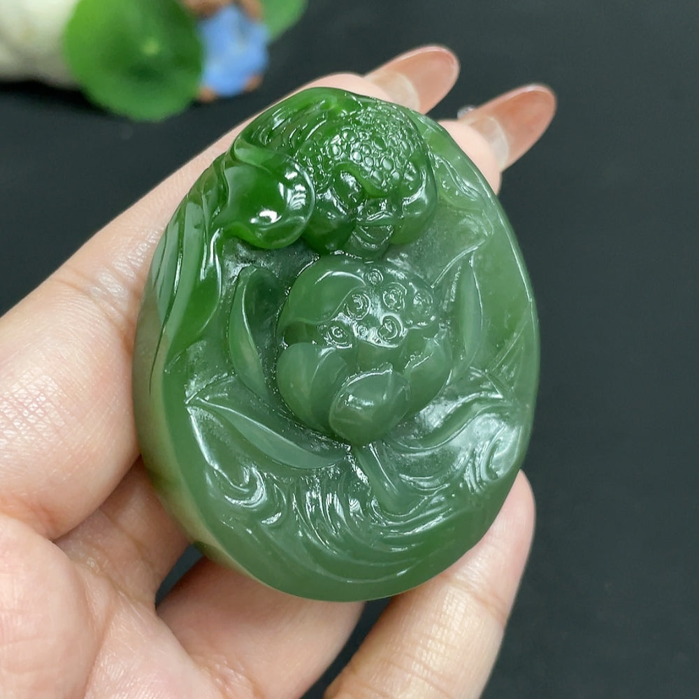 Huiliu certified Hetian jade jasper pendant featuring a lotus and fish symbolizing abundance, with intricate carved details.