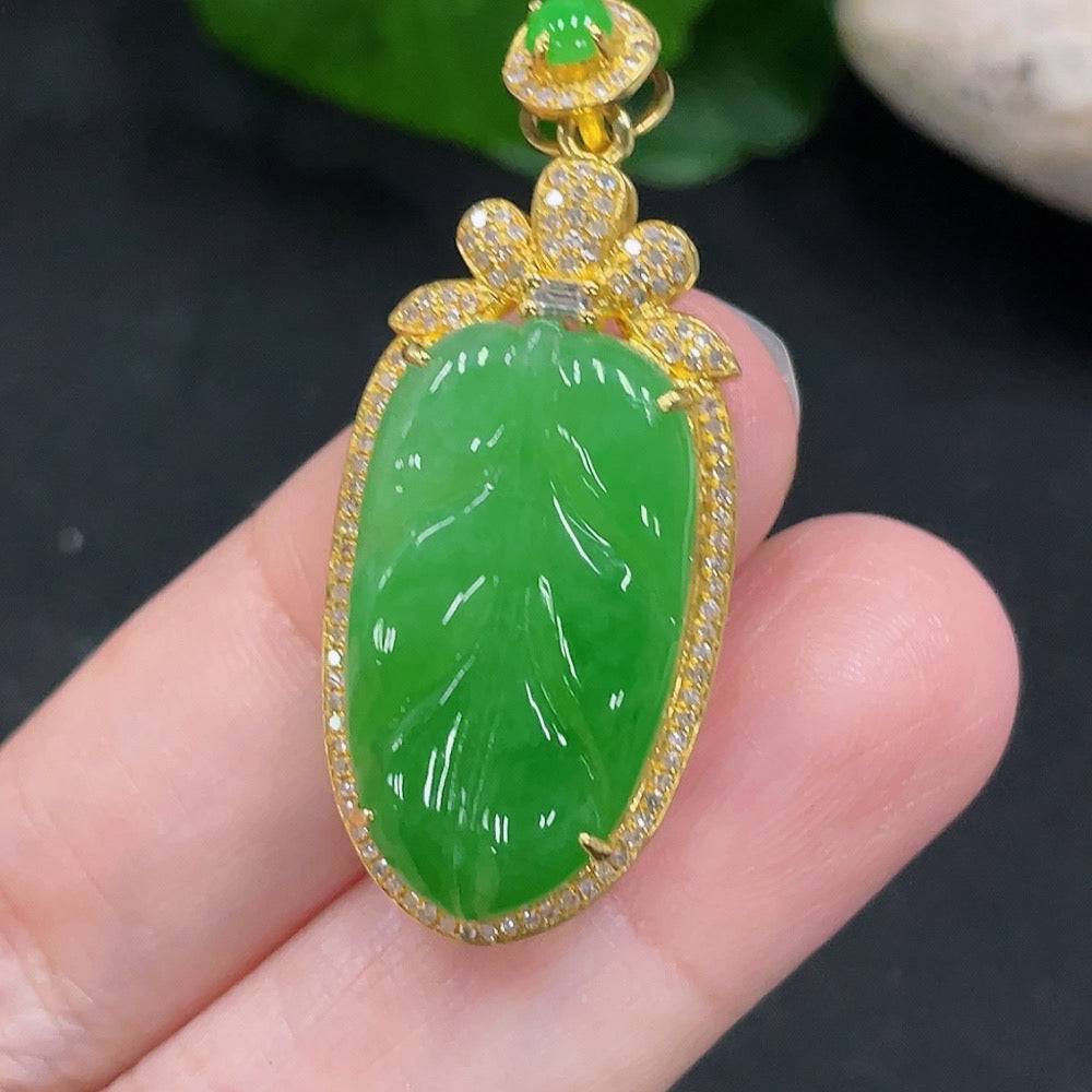 Jadeite leaf inlay pendant with diamond accents in 18K gold, from HUILIU HQ, weighing approximately 6 grams.
