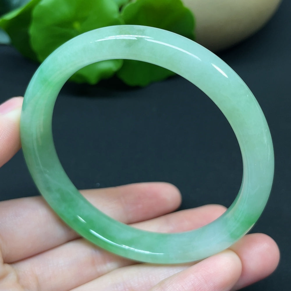HKHQ jadeite round bangle, size 54.7, 37.95g, showcasing smooth, polished green jadeite bracelet on a white background.