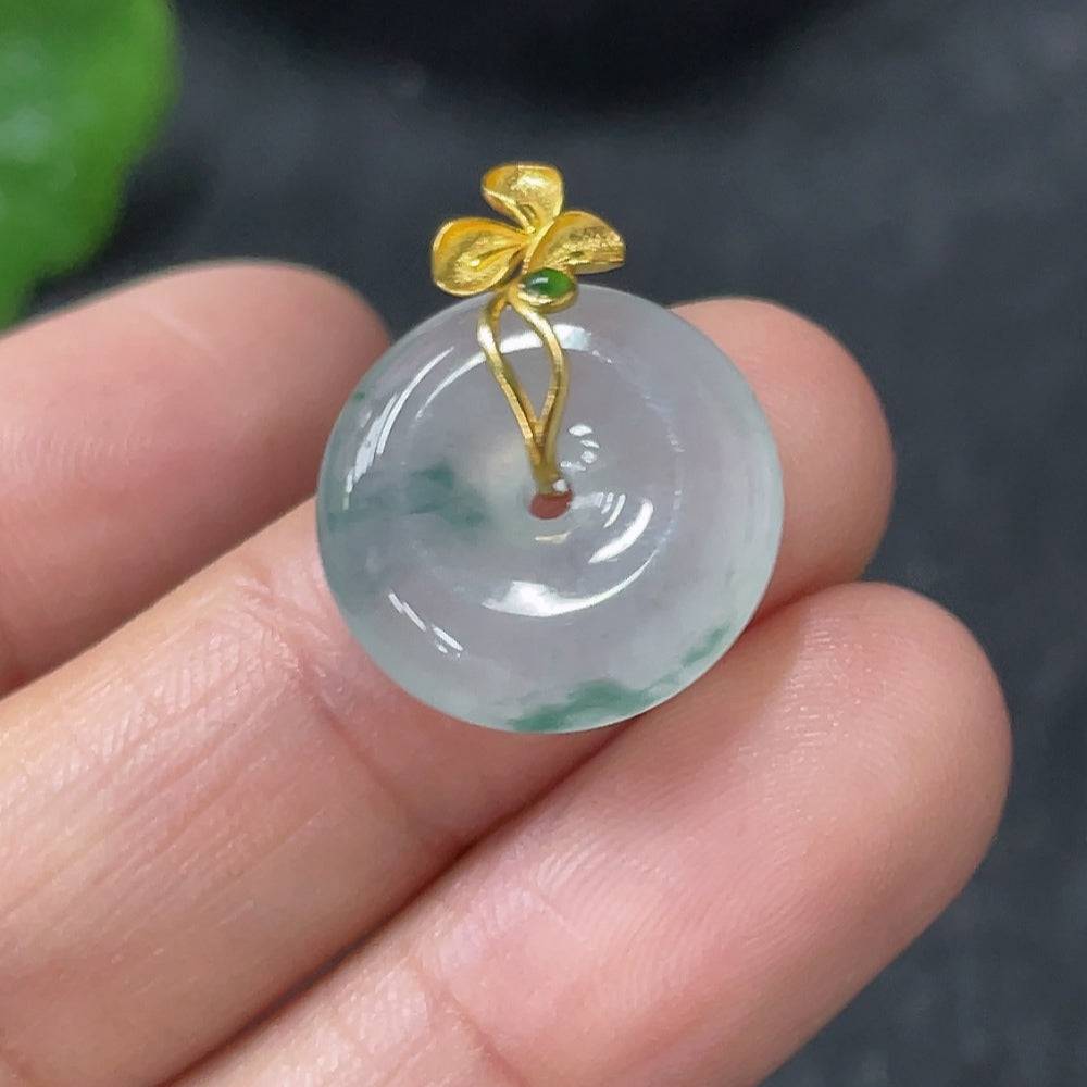 Jadeite peace knot pendant with 18k gold clasp, weighing approximately 2.74g, featuring smooth green jade stone and detailed craftsmanship.