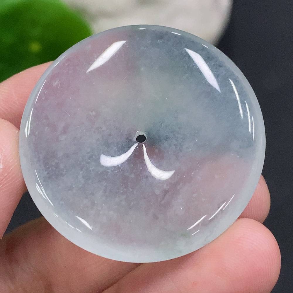 Close-up of a jadeite Jade Peace button from HUILIU HQ, showing smooth, polished jade surface with carved peace symbol.