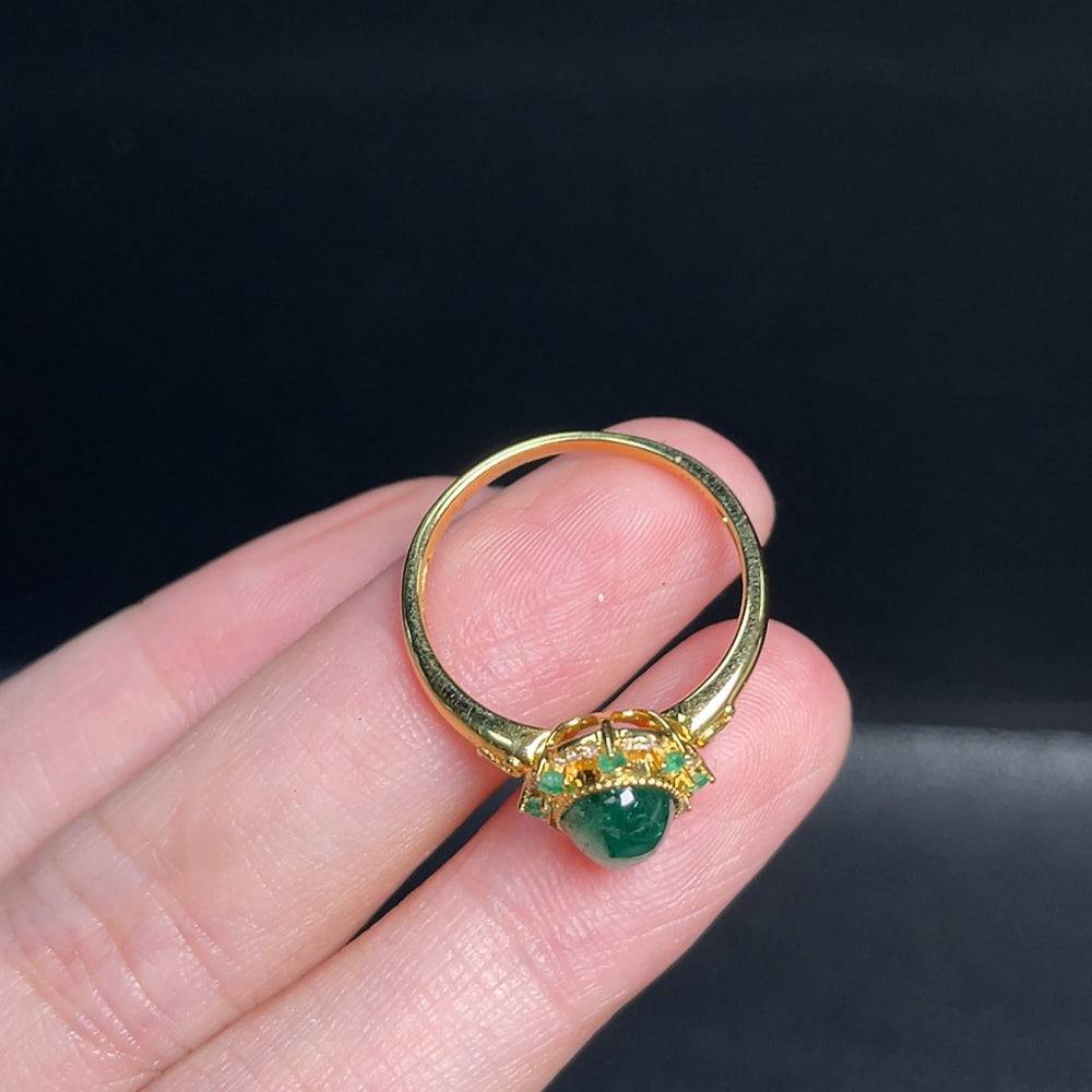 Huiliu emerald ring with colorless diamond accents, clarity enhanced, featuring natural-looking gemstones in a close-up shot.