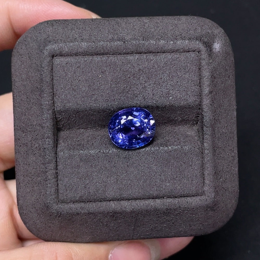 4.45-carat tanzanite loose gemstone from HKHQ, showcasing vibrant blue-purple color and faceted cut on a jewelry display.