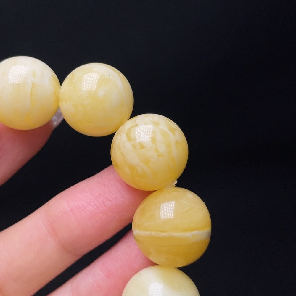 Amber beeswax bead bracelet by HUILIU HQ featuring amber beads with non-metal accents, showcasing natural warm tones and textured surface.