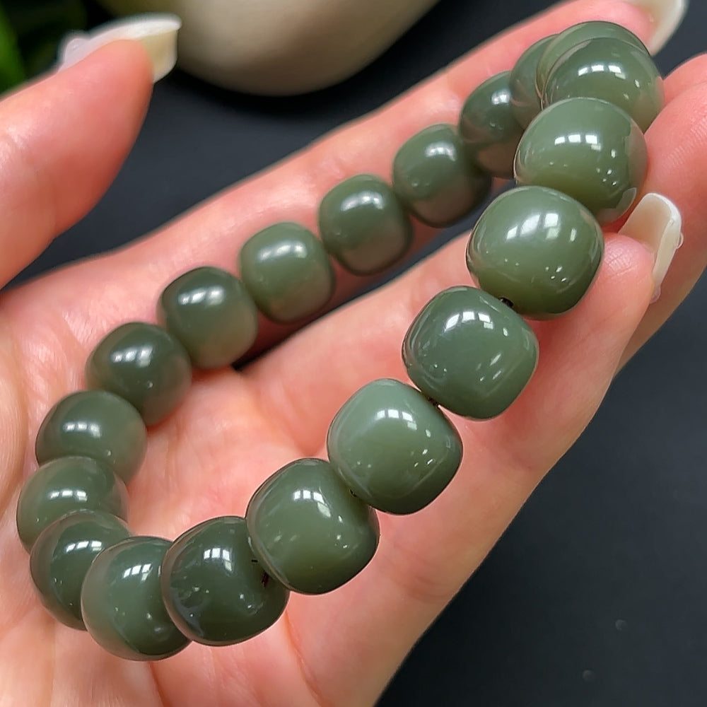 Hetian Jade bracelet with 12mm beads from HKHQ, showcasing smooth, polished green jade stones on a flexible bracelet.