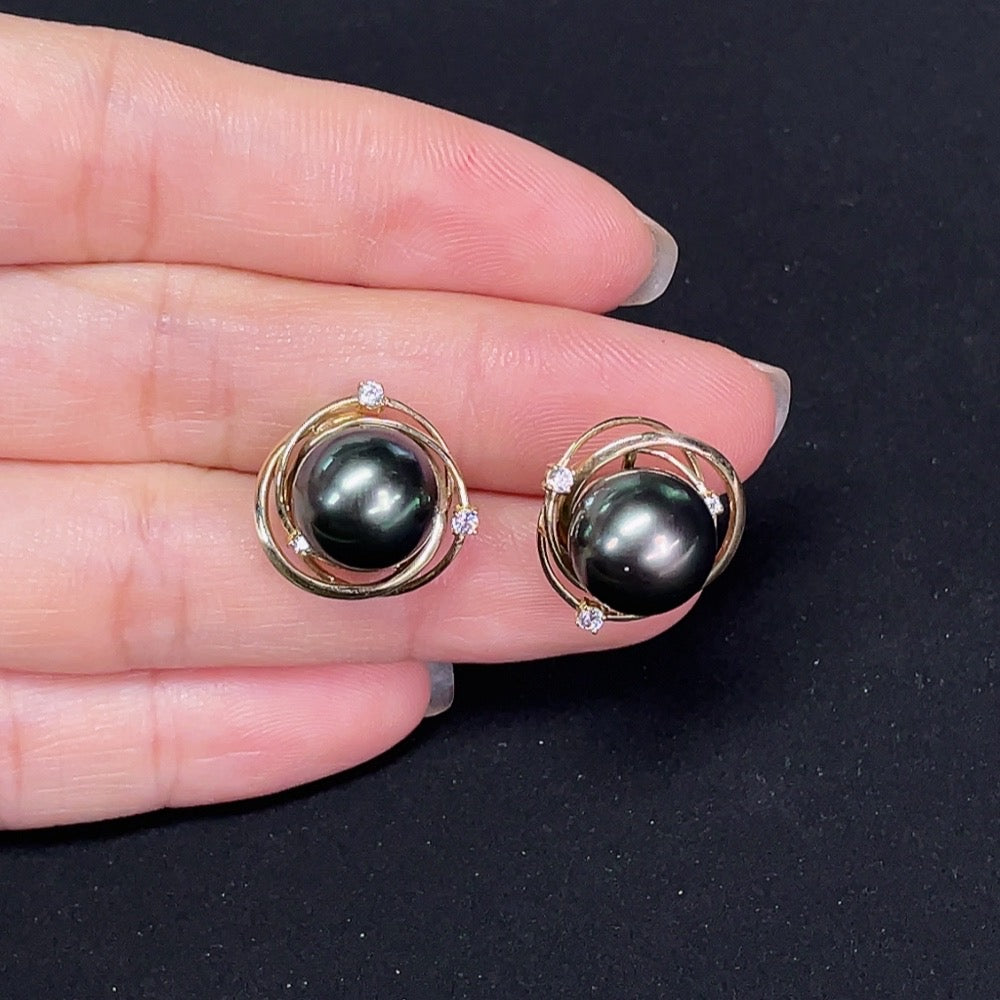Saltwater pearl stud earrings in 14K gold by HKHQ, featuring elegant, round pearls on classic earring posts.
