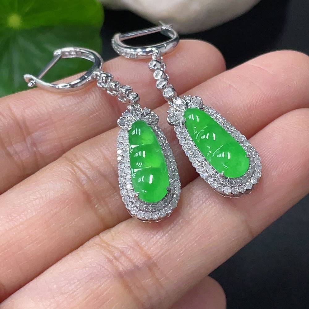 Jadeite earrings with 18k gold and diamond accents, featuring carved jade stones and elegant jewelry design.