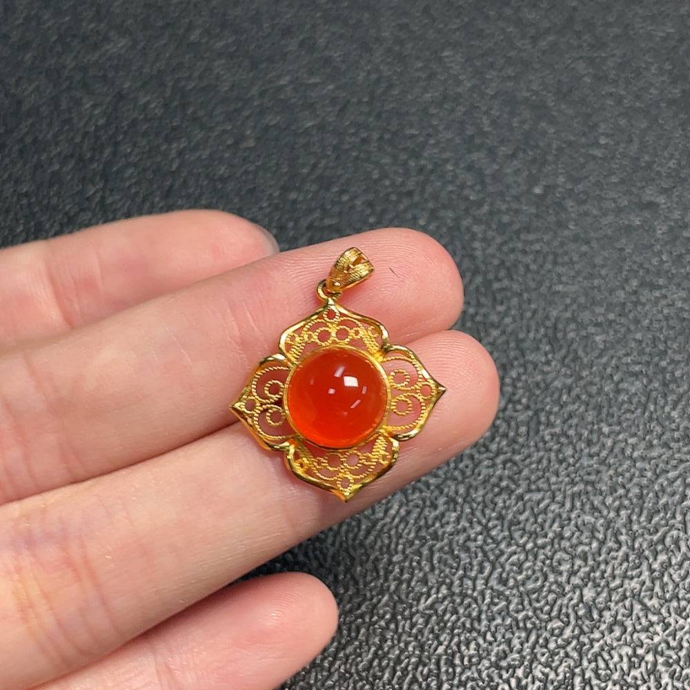 Red Agate gemstone pendant from HUILIU HQ featuring a polished, teardrop-shaped red agate stone on a silver chain.