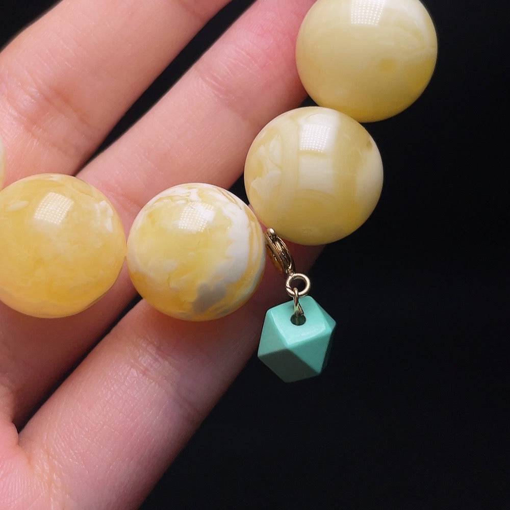 Huiliu Amber Beeswax Bead Bracelet with non-metal accents, featuring round amber beads and decorative non-natural elements.