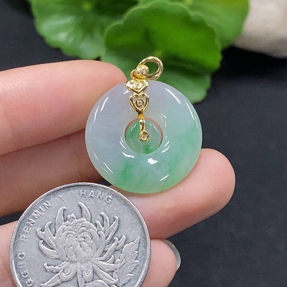 Jadeite mother-and-son pendant with 18K gold and diamond accents, showcasing intricate inlay work and elegant craftsmanship.