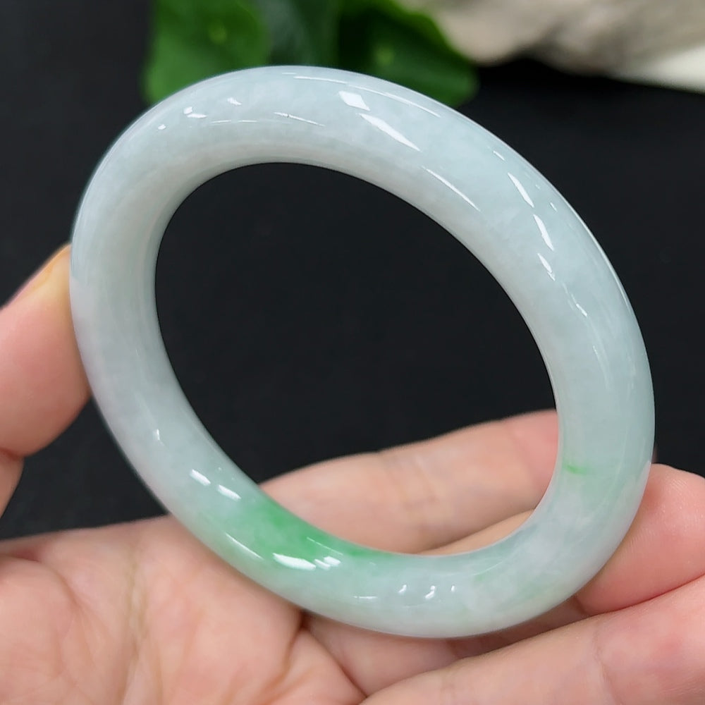 HKHQ jadeite round bangle in size 55, showcasing smooth, polished jadeite with a glossy finish and elegant round shape.