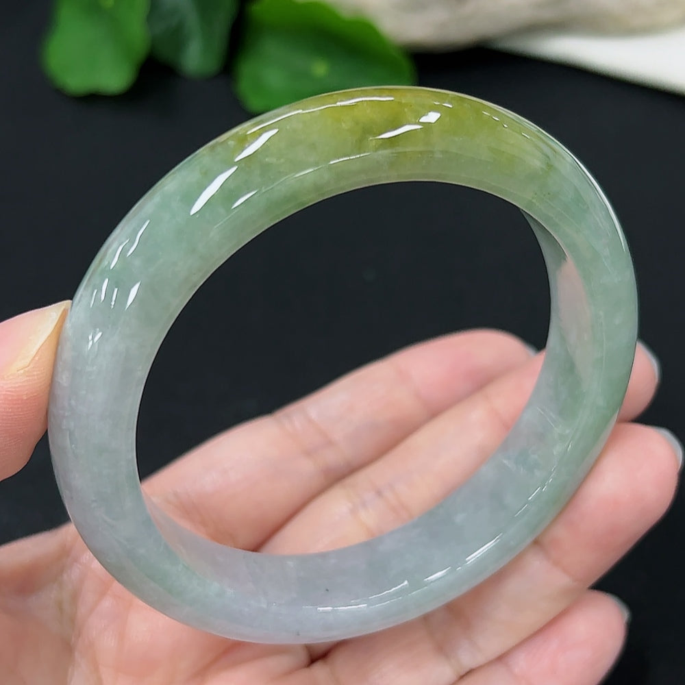 HKHQ Jadeite round bangle in size 58, showcasing smooth, polished green jade with a rounded shape and elegant design.