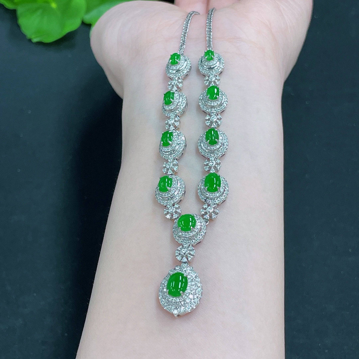 Huiliu Jadeite necklace set with diamonds, featuring a elegant jade pendant and matching earrings on a white background.