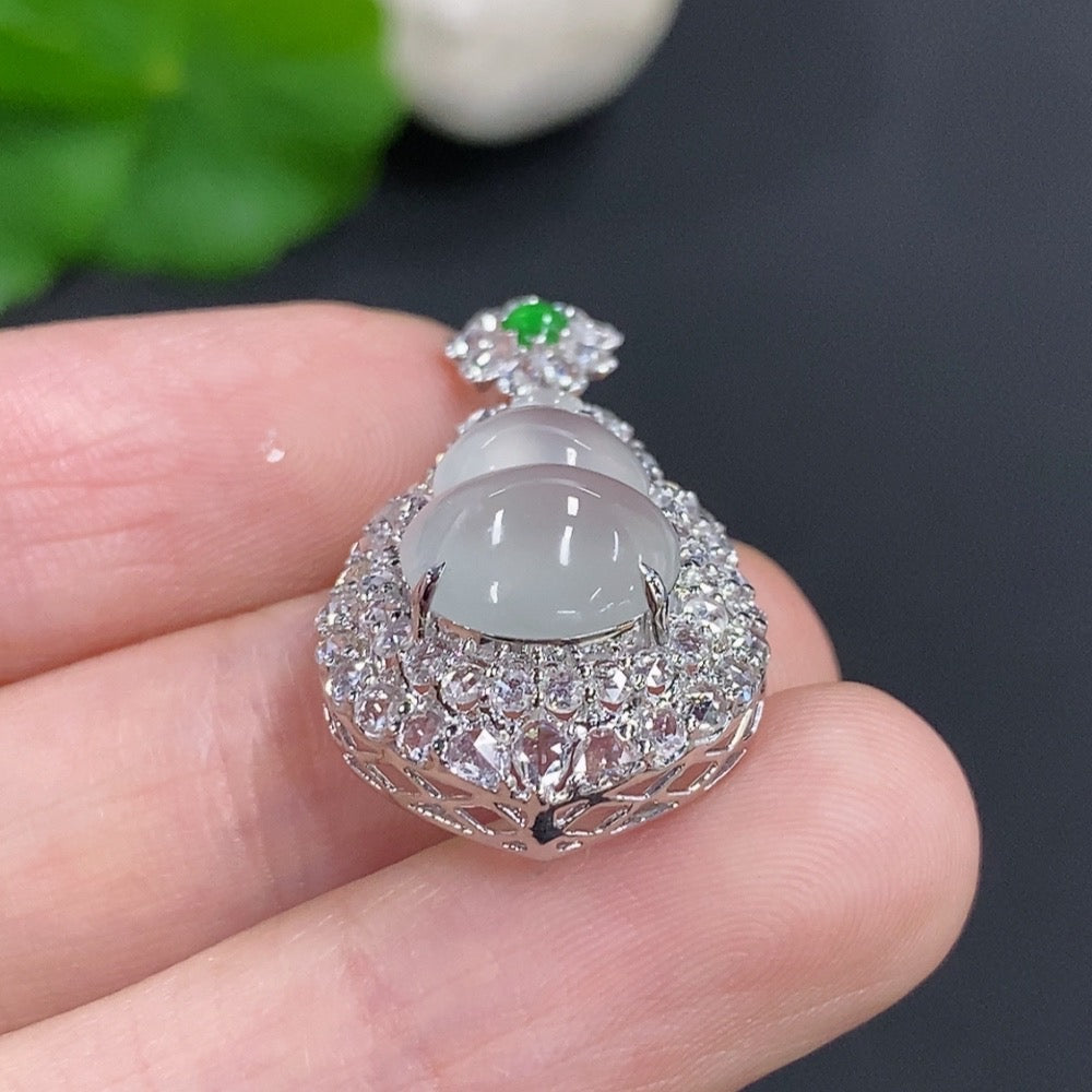 Jadeite gourd pendant with 18K gold mounting, accented with diamonds, showcasing smooth green jade and elegant jewelry design.