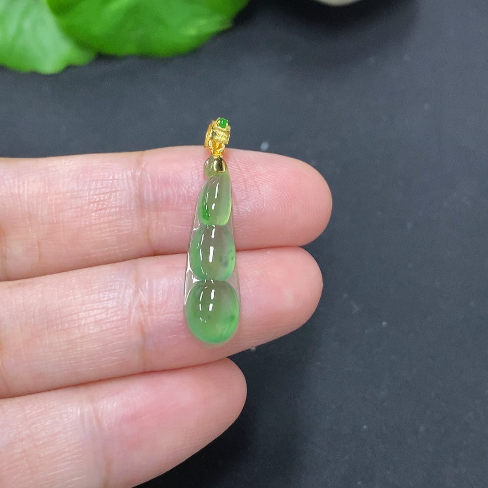 Jadeite lucky bean pendant with 18K gold clasp, smooth green jade with a polished finish, weighing about 1g, by HKHQ.