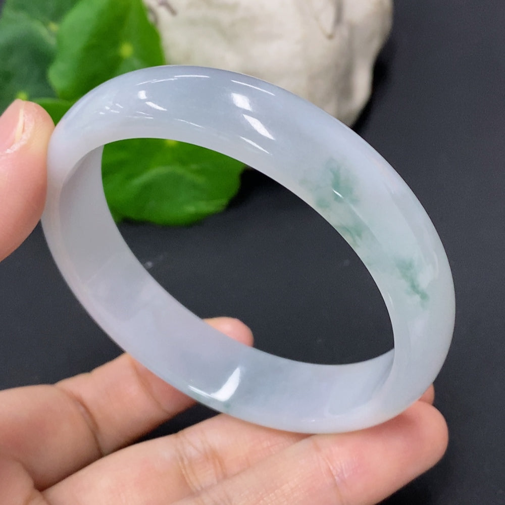 Jadeite round bangle by HKHQ, smooth jade surface, size 59.2 with a total weight of 52.4 grams, close-up view of the jewelry piece.