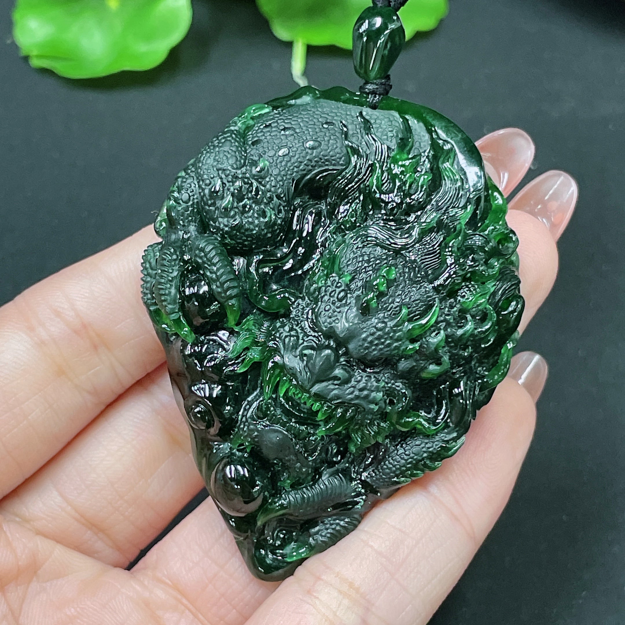 HUILIU HQ jadeite pendant featuring a carved dragon plaque, weighing approximately 49.58 grams, with intricate jade craftsmanship.
