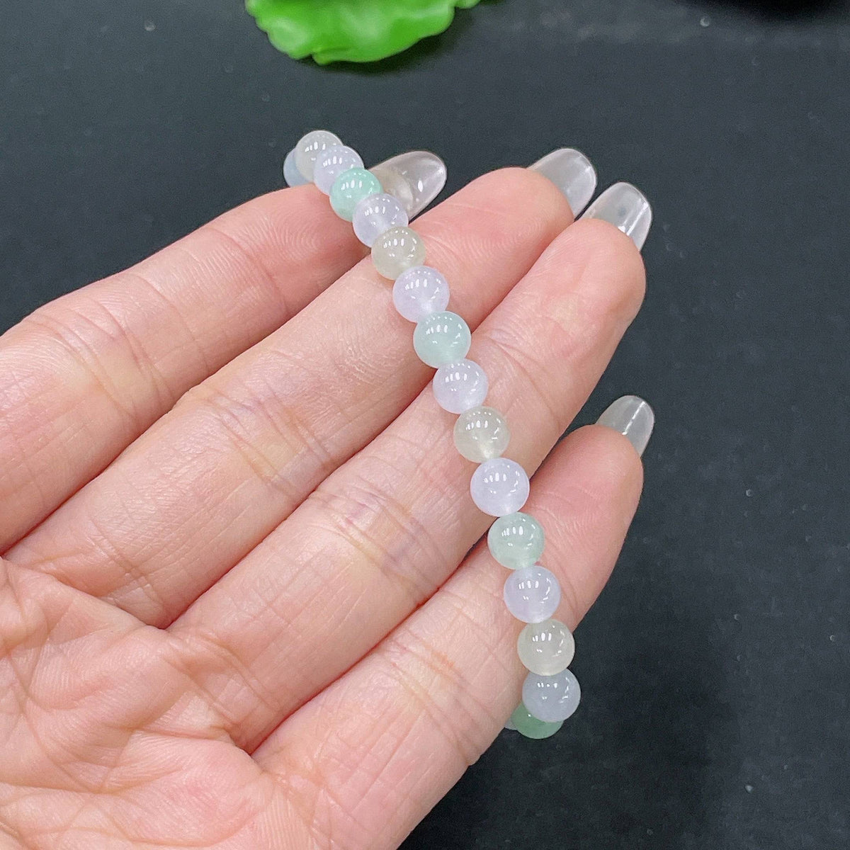 HUILIU HQ jadeite bracelet with 5.6mm beads, approximately 10.12g, showcasing smooth, polished jade stones on a delicate bracelet.