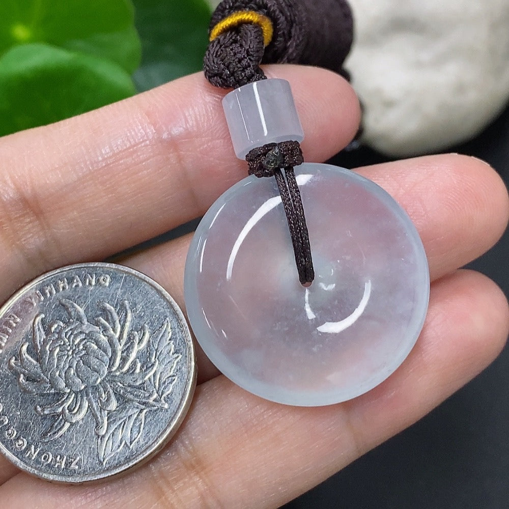 Jadeite pendant with peace knot design from HKHQ, weighing approximately 14.58g including cord, featuring vibrant green jade stone.