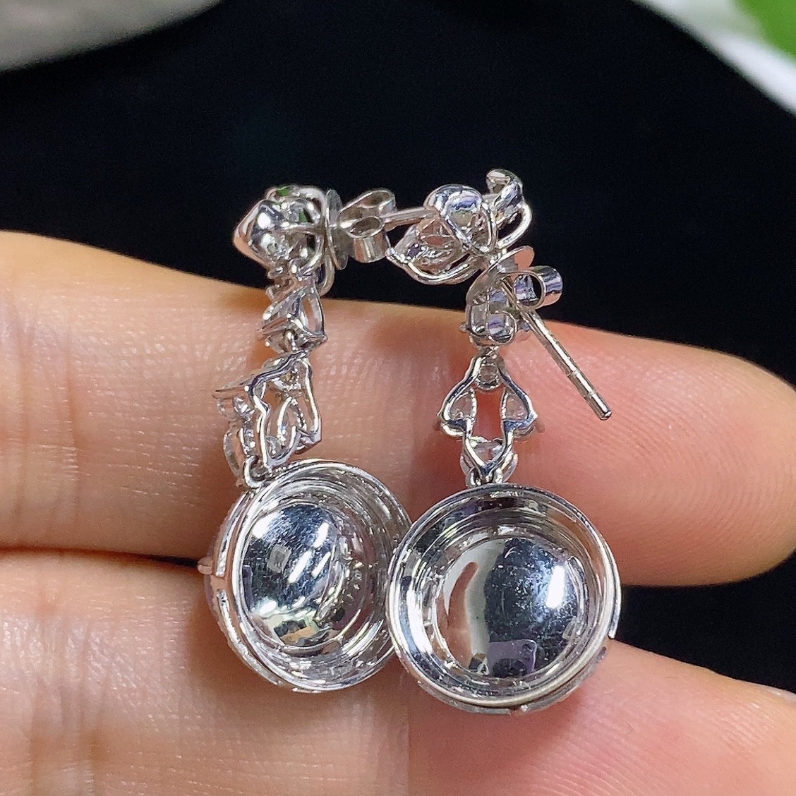 HKHQ jadeite cabochon earrings with 18K gold setting, showcasing elegant green jade stones in a stylish earring design