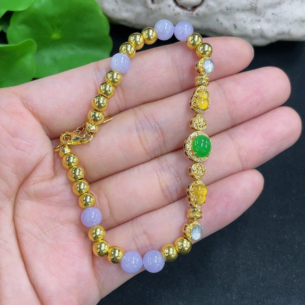 Jadeite bead bracelet with mixed gold components, stylish jewelry accessory featuring green jade beads and gold accents.