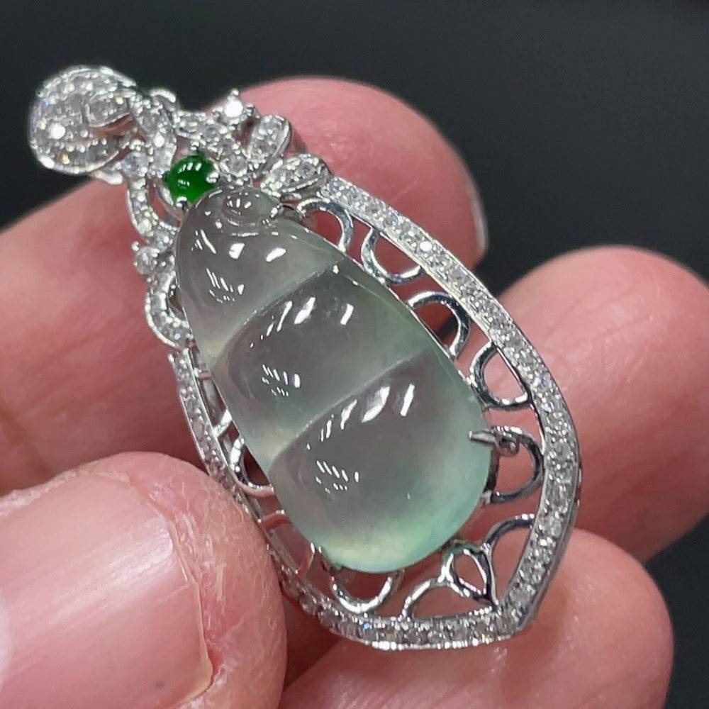 Jadeite blessing bean pendant with 18K gold setting and diamond accents, featuring a carved jade bean from HUILIU HQ.