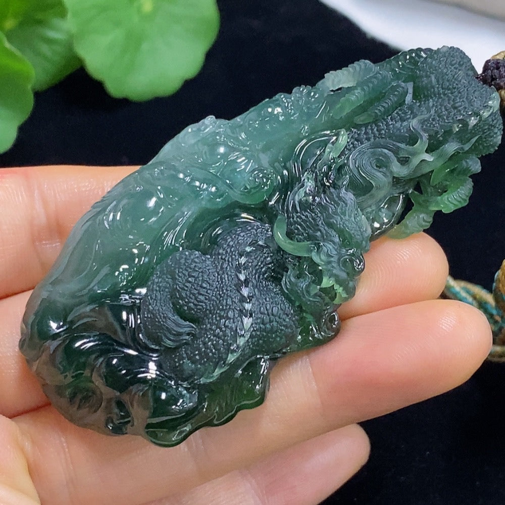 Jadeite pendant featuring a carved dragon plaque from HUILIU HQ, weighing approximately 60g including rope, with detailed jade craftsmanship.