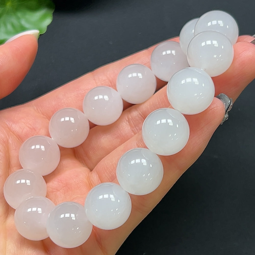 Hong Kong HQ Hetian Jade bracelet featuring 14mm smooth, polished jade beads on an elegant bracelet design.