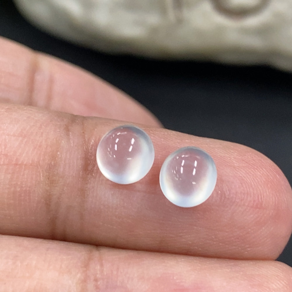 Close-up of a 0.49g jadeite cabochon jewelry piece by HKHQ, showcasing its smooth, polished green gemstone surface.