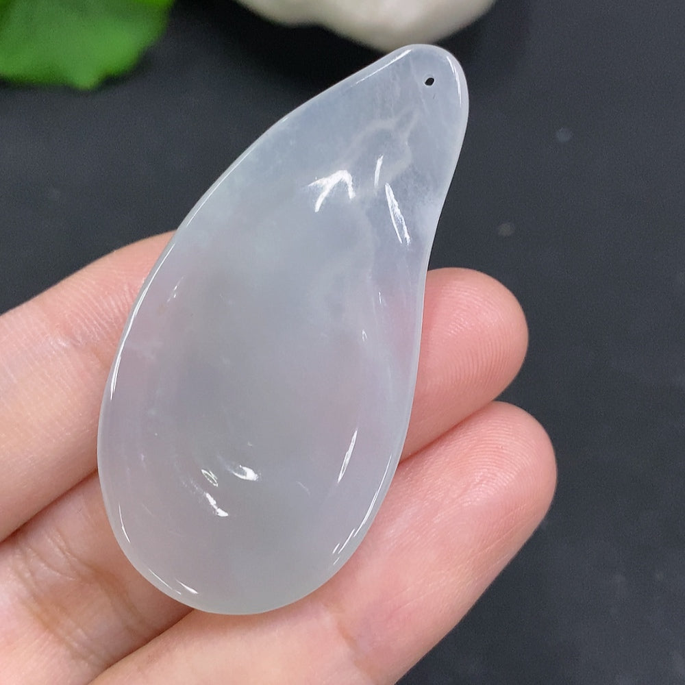HUILIU HQ Jadeite Guanyin pendant featuring a detailed carved figure of Guanyin in green jade, displayed against a neutral background.
