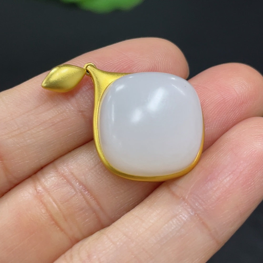 Hetian jade inlaid pendant necklace with 18K gold setting, featuring intricate craftsmanship and a polished jade stone.