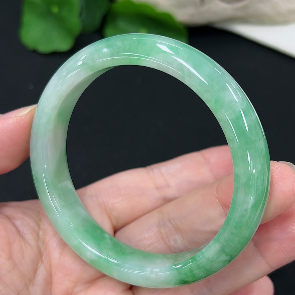 Jadeite round bangle with size 55.1 and weight 50.4g, showcasing smooth green jade surface and polished finish.