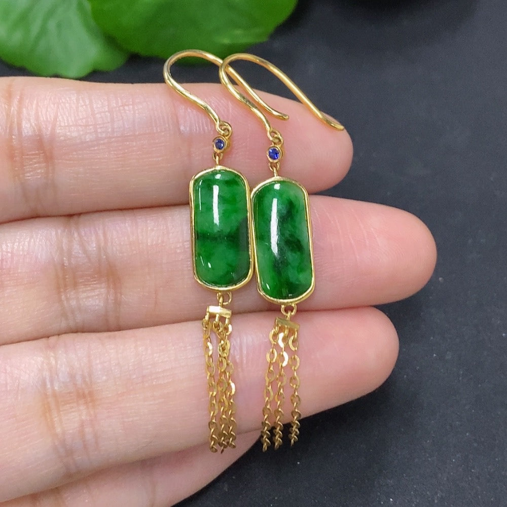 Jadeite earrings with 18K gold settings featuring smooth, polished jadeite stones and elegant gold hooks.