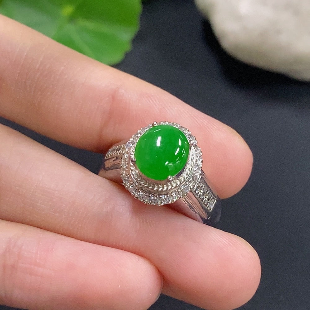 Jadeite cabochon gemstone set in a non-gold jewelry setting, showcasing smooth, polished green jadeite with a sleek design.