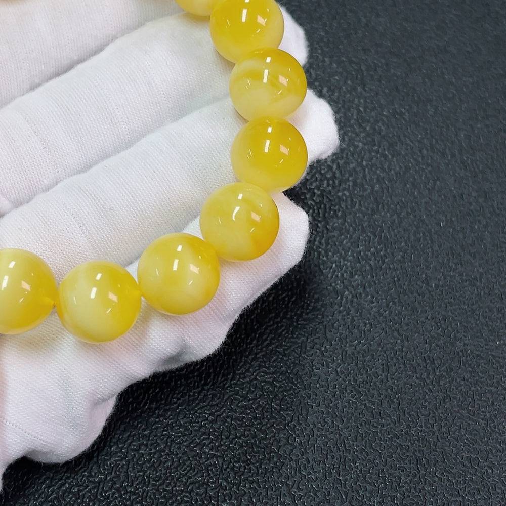 Huiliu Amber Beeswax Bracelet with 12.6mm beads, natural amber jewelry featuring warm honey tones and smooth round design.
