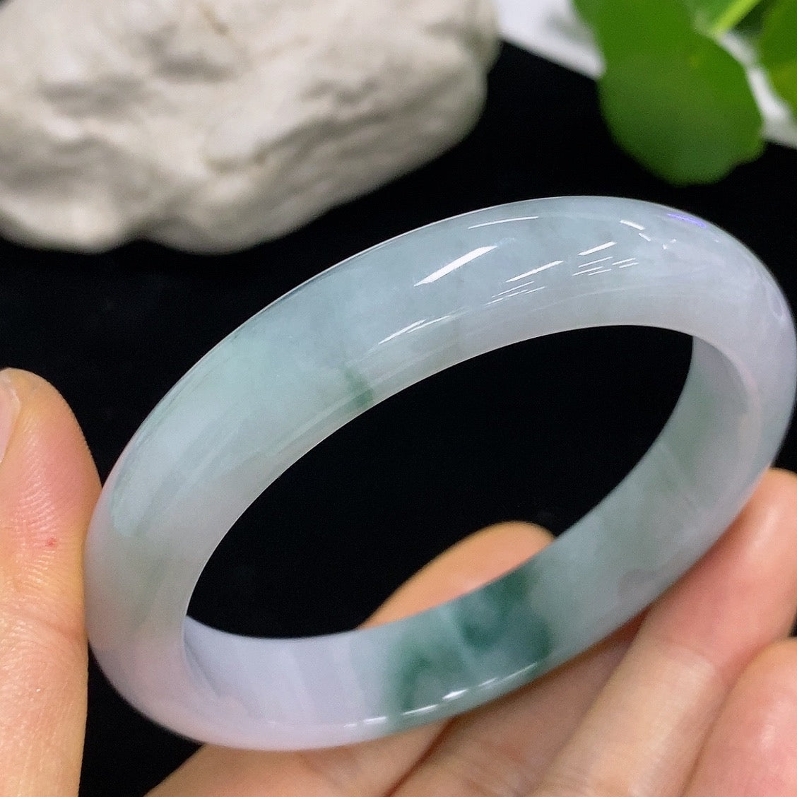 Jadeite round bangle by HKHQ with size 57.3 and weight approximately 50.05g, showcasing smooth, polished jade surface.