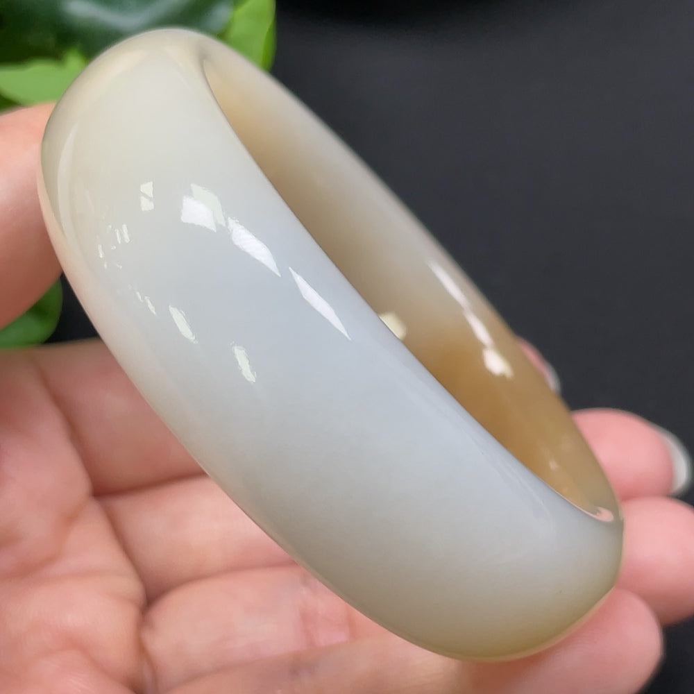HKHQ Hetian Jade round bangle in size 55.2 with a polished surface, weighing 83.44g, showcasing smooth craftsmanship and vibrant green jade.