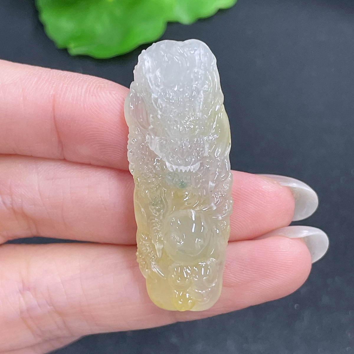 Jadeite pendant featuring a carved dragon plaque, weighing approximately 10g, showcasing detailed craftsmanship and vibrant green jade.