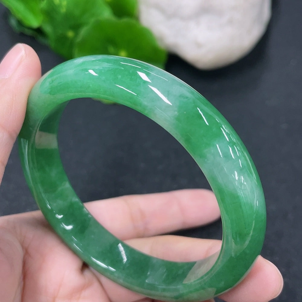 HKHQ jadeite round bangle with a 53.8mm diameter, showcasing smooth polished surface and elegant green gemstone appearance.