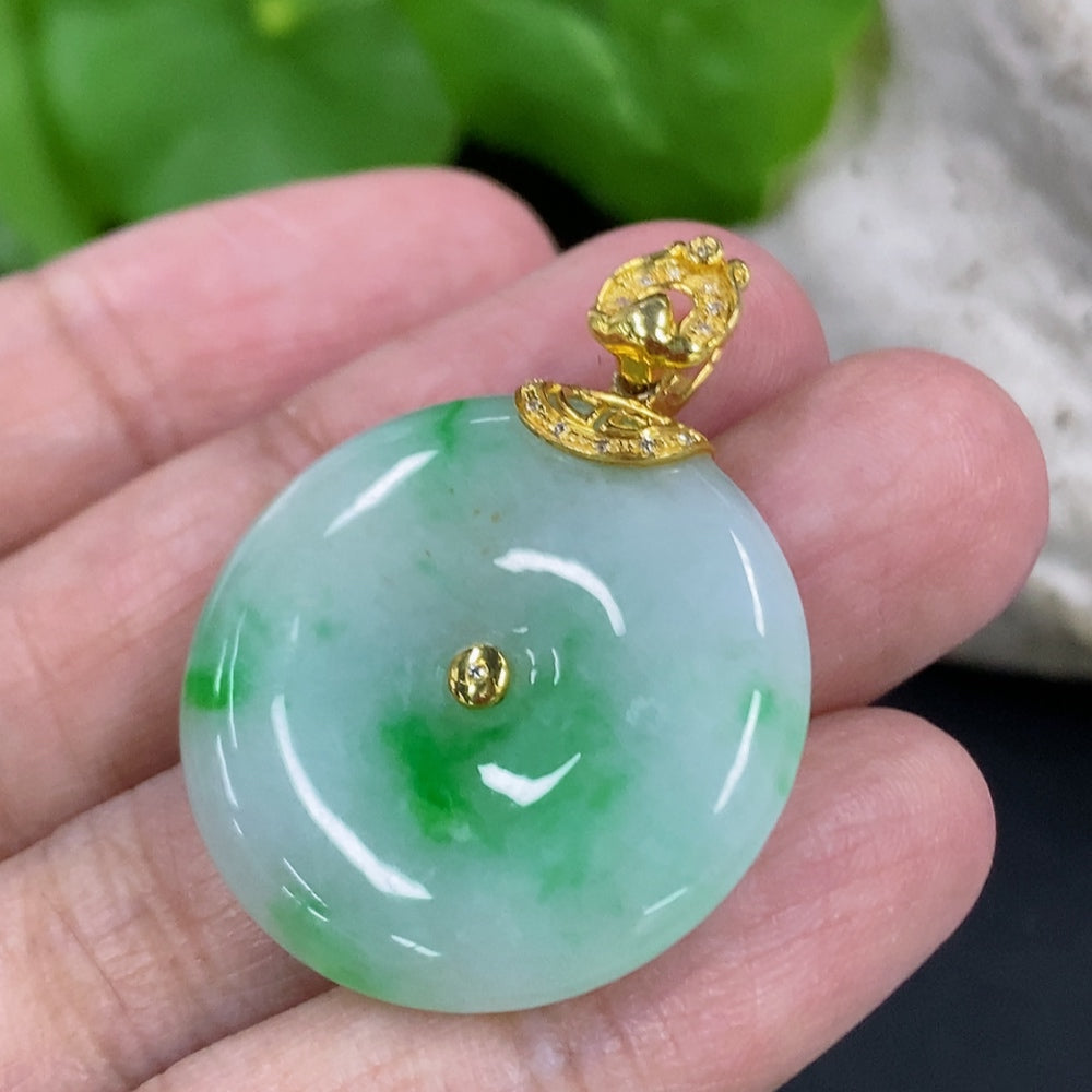 Jadeite peace knot pendant with 18K gold clasp and diamond accents, weighing approximately 8.55g, displayed on a neutral background.
