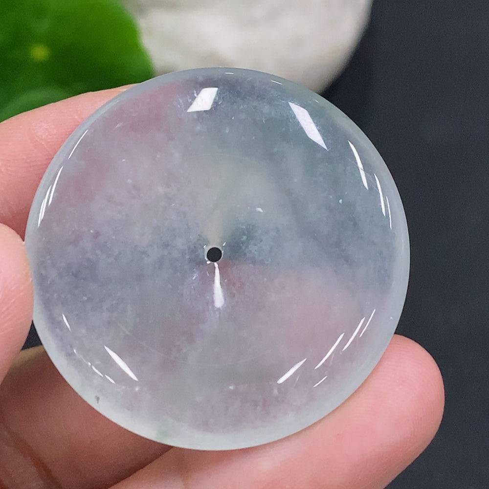HUILIU HQ JadeitePeace button made of green jade with carved peace symbol, natural polished stone, close-up view