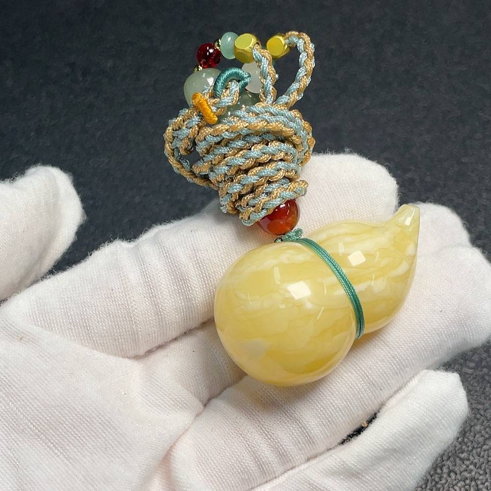 Huiliu Amber Beeswax Pendant with Rope, natural amber jewelry piece, handcrafted and certified by HUILIU HQ.