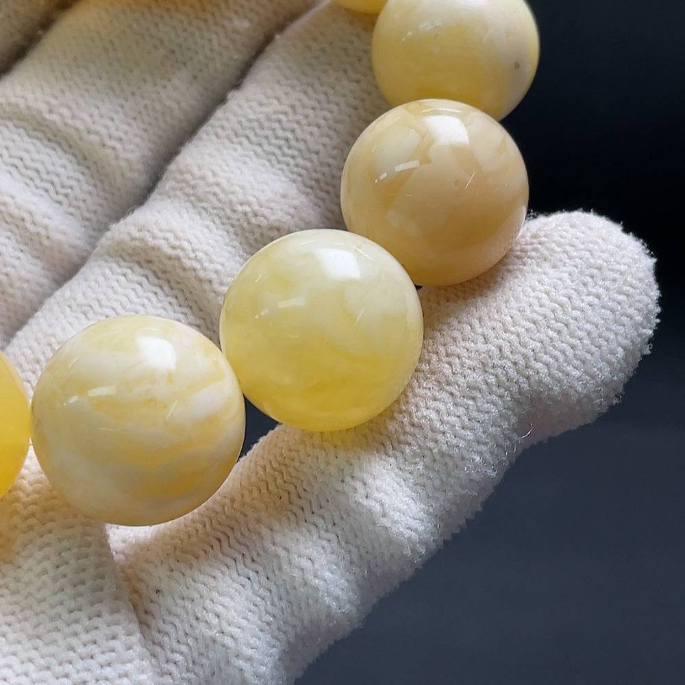 Huiliu Amber Beeswax Bracelet with 15.1mm beads, natural amber color, crafted by HUILIU HQ, showing the bracelet's detailed texture.