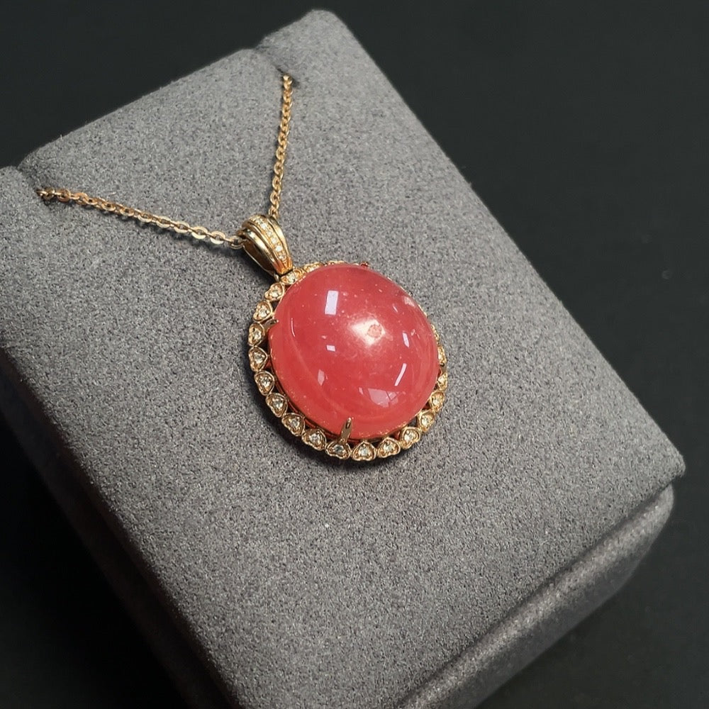 Rhodochrosite gemstone necklace with organic inclusions, 18K gold accents and diamond details, weighing approximately 9.47g.