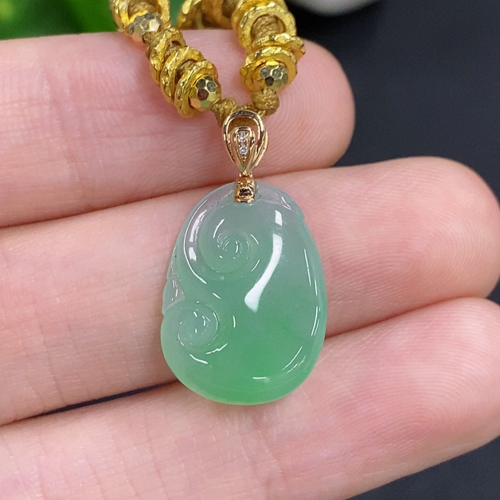 Jadeite Ruyi pendant by HKHQ with 18K gold accents and diamond details, showcasing smooth green jade and intricate craftsmanship.