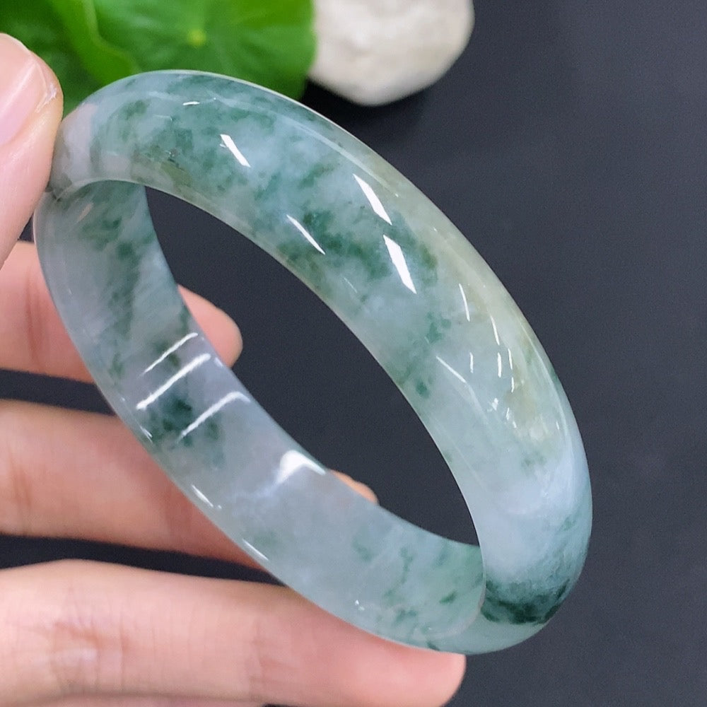 HKHQ jadeite oval bangle in size 58.8 with 47.7g, showcasing smooth, polished green jadeite jewelry on a white background.