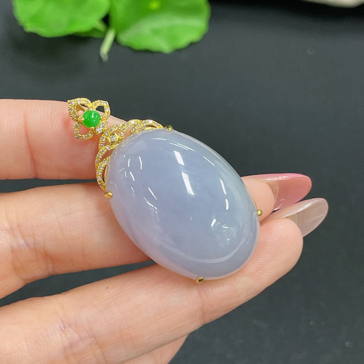 Jadeite pendant with 18k gold inlay and diamonds, showcasing a detailed jade gemstone on a delicate gold chain.